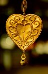 Golcolored heart charm.