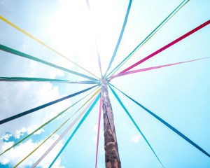 A Maypole with colorful ribbons around it.