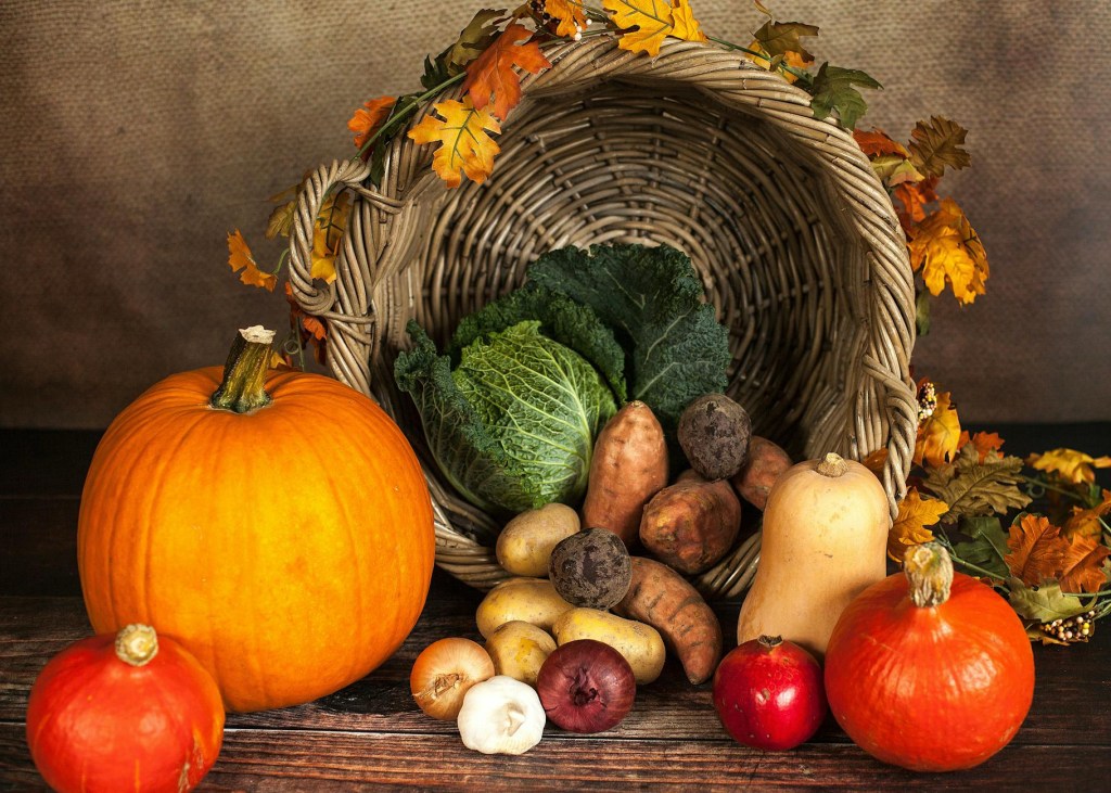 A cornucopia with a harvest of fruits and vegetables.