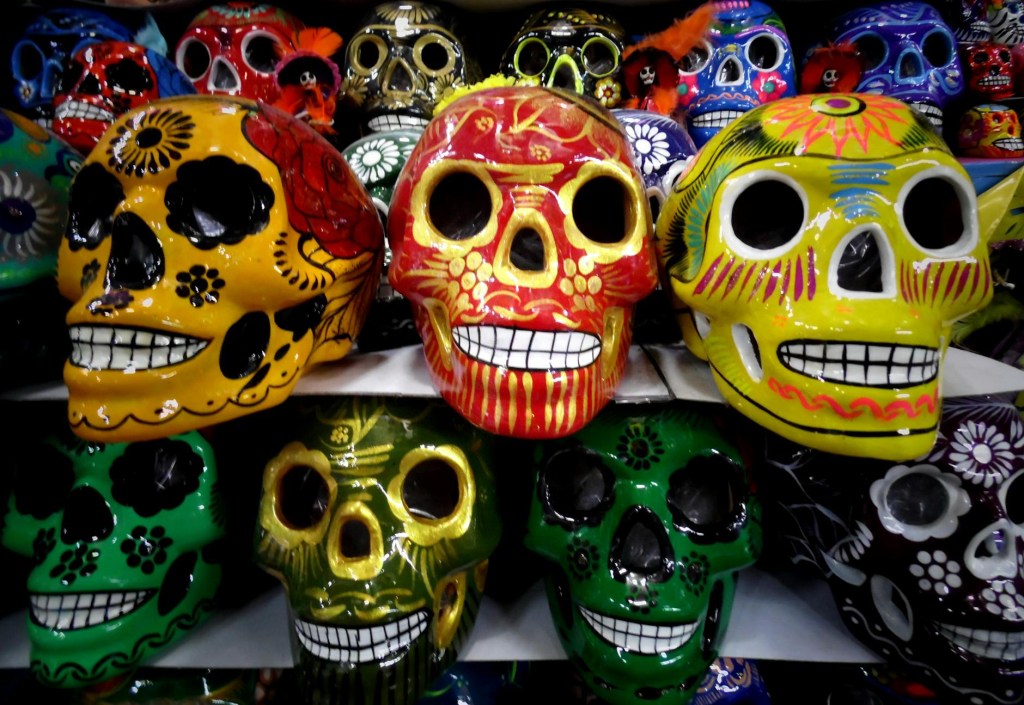Rows of skulls painted in different colors.
